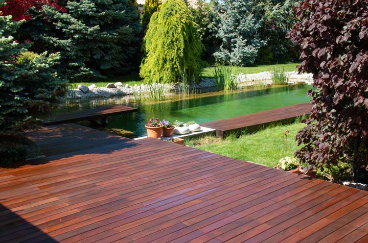 ipe wood deck access to indoor swimming pool in backyard