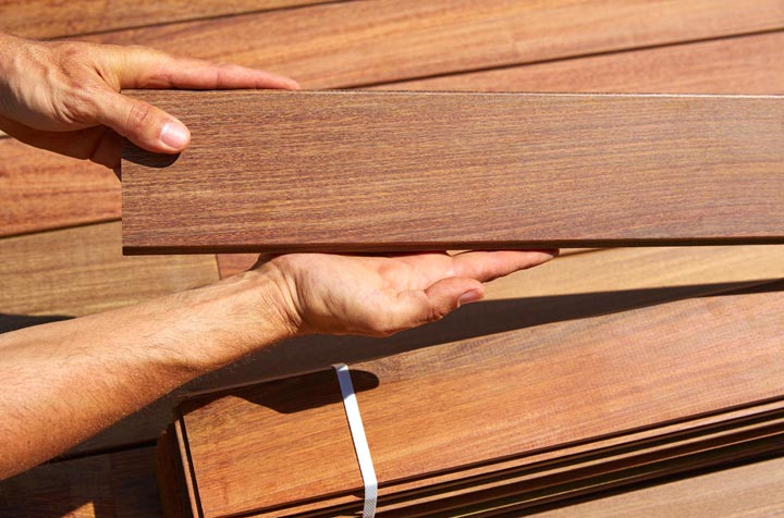 man holding individual ipe wood decking board